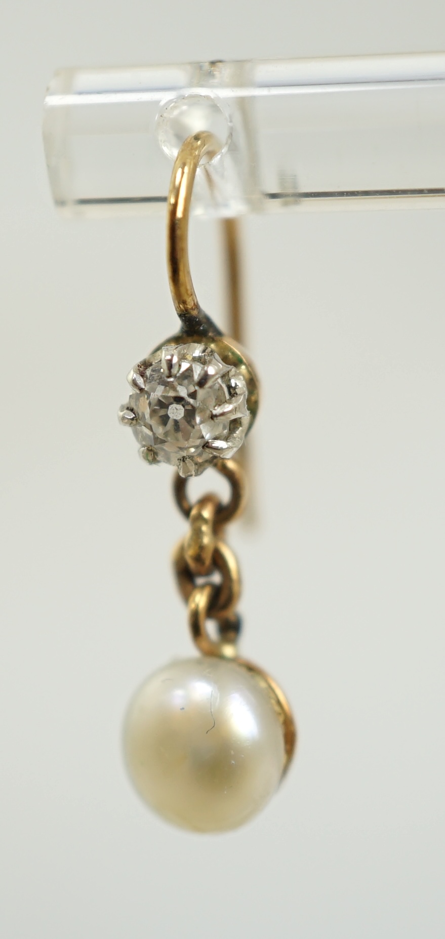 A pair of late 19th/early 20th century gold, single stone diamond and single stone button pearl set drop earrings